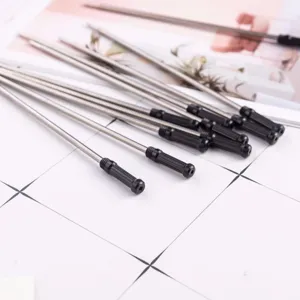 Closeup shot of metal ballpoint pen refills with black tips, showing fine details and quality.