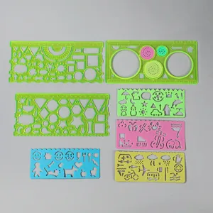 Detailed view of multi-functional plastic drawing template rulers and geometric stencils.