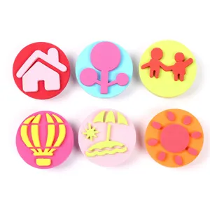 Children sponge stamps detail showing various cute patterns like house tree and hot air balloon.