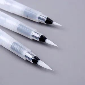Close-up of three watercolor water brush pens with white nylon hair tips and clear barrels.