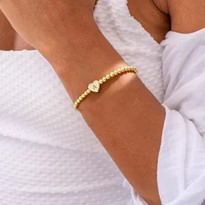 18K gold plated stainless steel bead bracelet with engraved heart letter A charm detail.