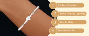 Stainless steel beaded stretch bracelet detail, heart charm with letter K engraving feature.