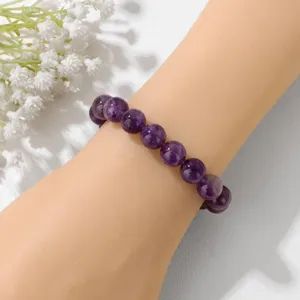 Detail view of natural purple amethyst gemstone beaded stretch bracelet, 10mm round beads.