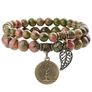 Close-up view of natural unakite stone double-layer beaded bracelet with vintage bronze tree charm.