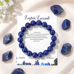 Natural lapis lazuli bead bracelet detail view with raw stone props and display card.