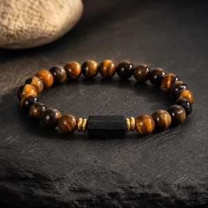 Detailed shot of tiger eye and black tourmaline beaded bracelet with golden metal spacers.