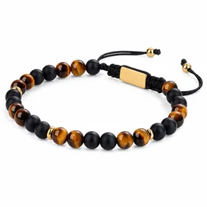 Close-up detail of tiger eye and black onyx beaded bracelet with adjustable braided cord.
