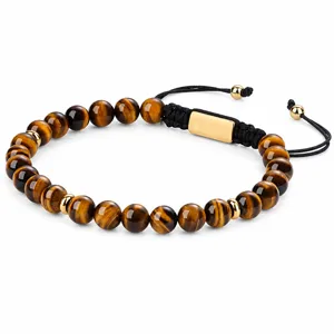 Close-up detail of the men's natural tiger eye stone beaded bracelet with metal charms.