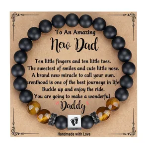 Detail shot of mens beaded bracelet with black matte and tiger eye stones for new dad gift.