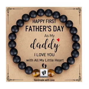 Father's day black matte and tiger eye stone beaded bracelet detail with engraved footprint cube.