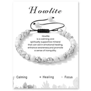 Detailed view of white howlite stone bead bracelet with adjustable black woven cord on display.