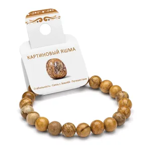 Close-up detail of natural picture jasper stone beaded bracelet on retail display card.