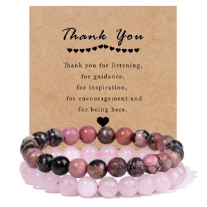 Close-up detail of double-layer beaded bracelet set with pink natural stone and thank you card.
