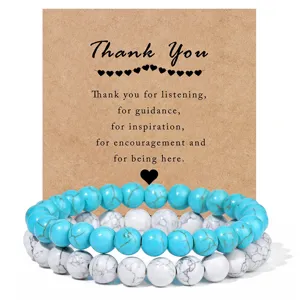 Detail view of beaded stone bracelets with thank you card packaging for couples and parties.