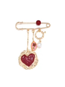 Vintage gold safety pin brooch featuring a red heart pendant, pearl charm and floral accent.