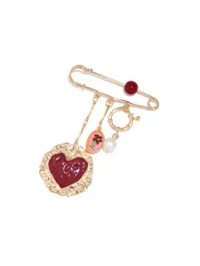 Vintage gold safety pin brooch featuring a dark red heart pendant and lovely flower charm.