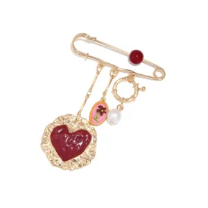 Vintage burgundy enamel heart brooch featuring pearl and multi-pendant chain design.