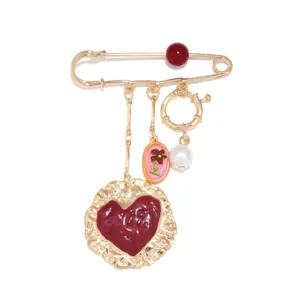 Vintage gold tone safety pin brooch with dark red enamel heart and pearl charms stylish