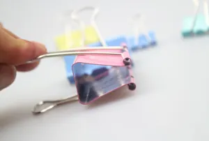Colorful metal binder clips set for office and school use, durable paper clamps in assorted colors.