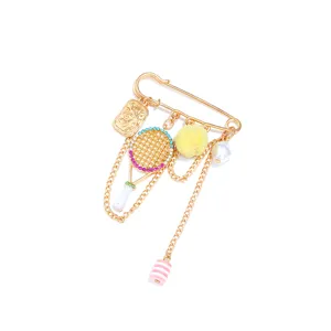 Close-up detail of a cute gold safety pin brooch featuring a crystal racket design.