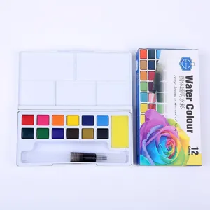 Close-up detail of 12-color solid watercolor paint set with water brush and palette box.