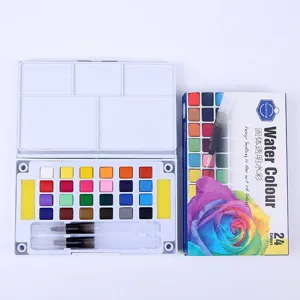 Close-up view of 24 color solid watercolor paint set with palette box and water brush pens.