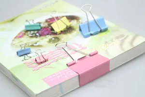 Colorful metal binder clips set for office and school document organization and paper sorting.