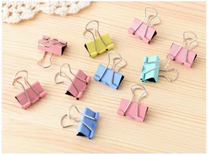 Colorful metal binder clips for office and school file organization, pastel assorted colors.