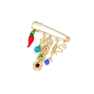 Bohemian multi charm safety pin brooch with red chili, fish, snake and rhinestones.