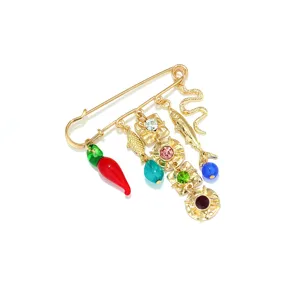 Bohemian multi-charm gold safety pin brooch with cute chili fish and crystal pendants.