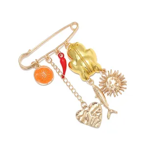 Gold-tone safety pin brooch featuring quirky enamel orange, chili, heart, fish and sun charms.