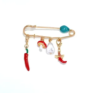 Detailed closeup of trendy cute enamel chili mushroom faux pearl safety pin brooch.
