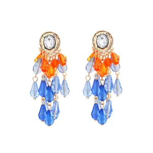Detailed view of long colorful crystal tassel earrings with blue and orange beads.