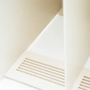 Close-up detail of white desktop bookend and document organizer slot structure clearly.
