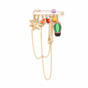Detailed view of a sweet and cute alloy brooch featuring cactus, sun and tassel charms.