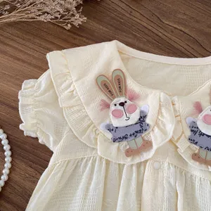 Primo piano della tutina in cotone per neonata con colletto a coniglietto e volant per l'estate.