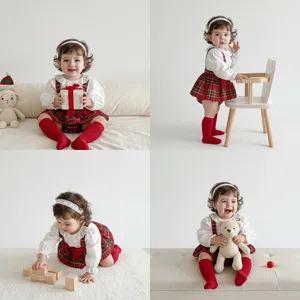 Cute infant baby girl red plaid suspender skirt set with long sleeve top and cute matching socks.
