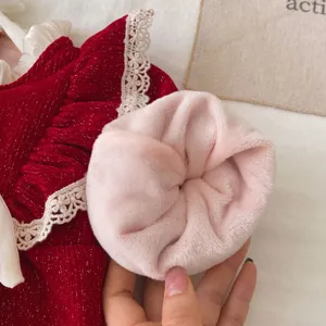 Detail view of the red fleece-lined baby girl romper with cute lace and plush accessories.