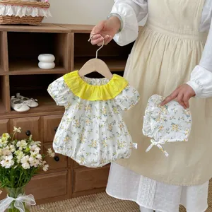 Lindo conjunto de mameluco floral para bebé niña con cuello de volantes amarillo, body de verano y gorro.