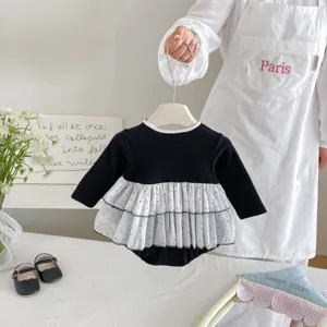 Infant baby girl black long sleeve polka dot mesh patchwork romper detail view showing texture.