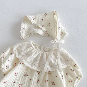 Detail shot of the sweet baby floral romper and matching bonnet with delicate lace collar.