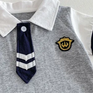 Detail shot of baby polo romper collar and embroidered badge, short sleeve grey white style.