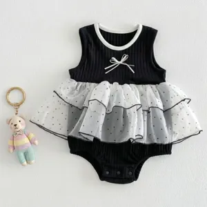 Cute infant baby girl summer sleeveless romper with black ribbed fabric and white polka dot mesh skirt.