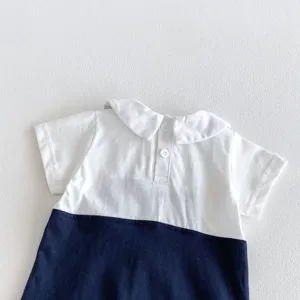 Baby boy summer short sleeve romper detail, white top and navy bottom contrast design.
