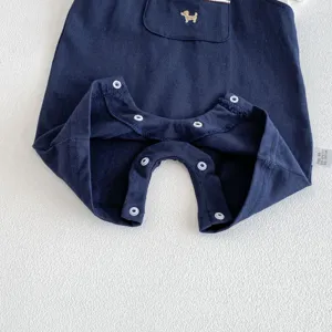 Baby boy summer romper detail view, dark blue cotton fabric with cute dog embroidery and snaps.