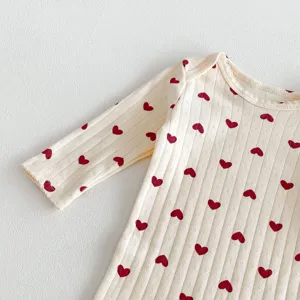 Baby cotton long sleeve romper detail with cute red heart print and soft ribbed fabric.
