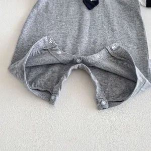 Baby summer short sleeve polo romper detail shot, cute grey cotton baby bodysuit with snap buttons.