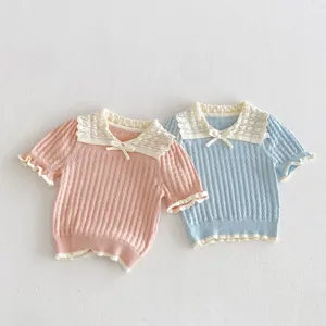 Detail view of cute girls short sleeve knit top with lace collar and sweet bow decoration.