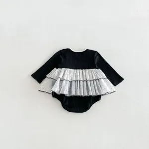 Close-up detail of baby girl long-sleeve romper with double layered polka dot mesh skirt.
