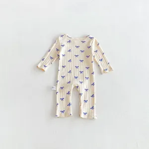 Detailed view of the baby long sleeve romper featuring cute blue bow prints and soft ribbed fabric.